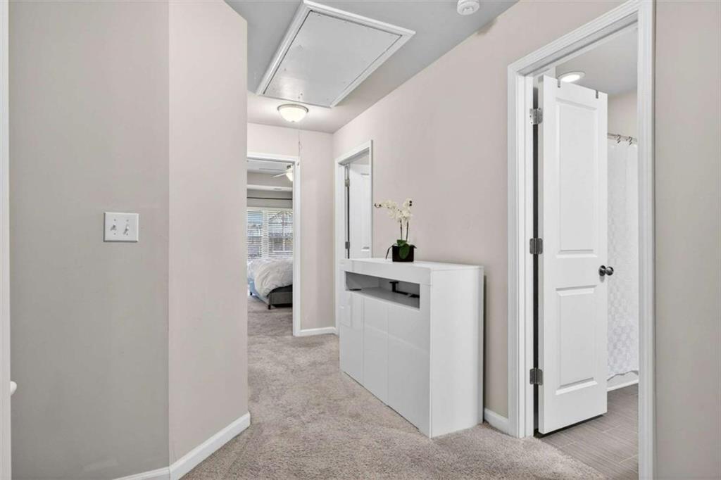3182 Meadowstone Lane Southwest Atlanta, GA 30331 - Photo 16 of 32 a hallway with white cabinets and white appliances