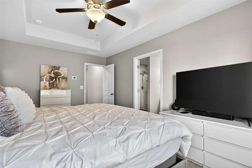 3182 Meadowstone Lane Southwest Atlanta, GA 30331 - Photo 18 of 32 a bedroom with a bed and a flat screen tv