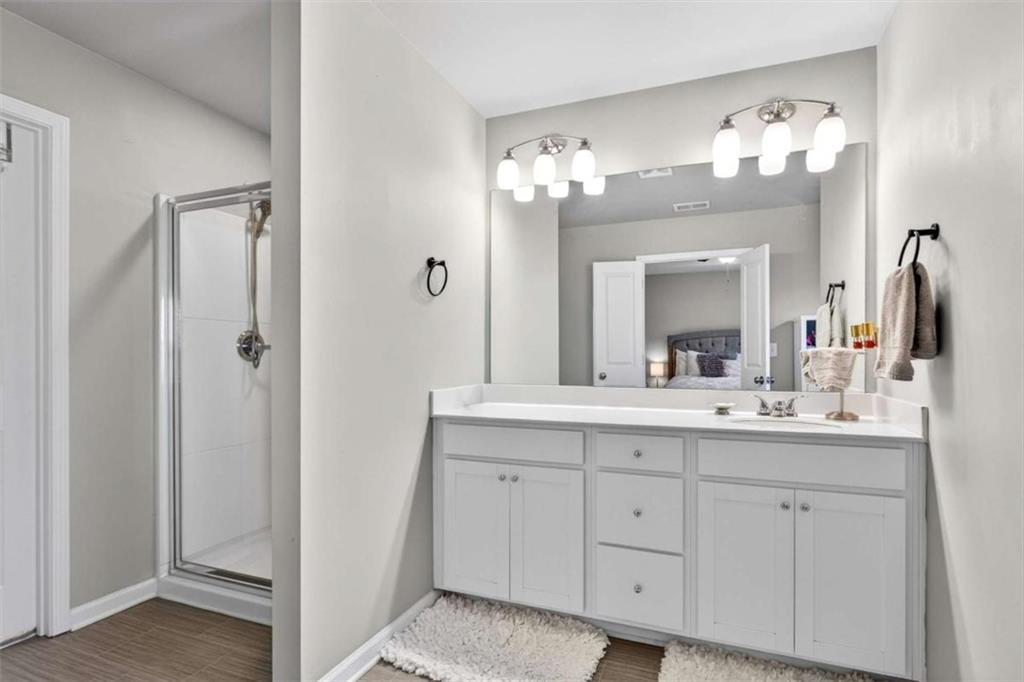 3182 Meadowstone Lane Southwest Atlanta, GA 30331 - Photo 19 of 32 a bathroom with a double vanity sink and a mirror