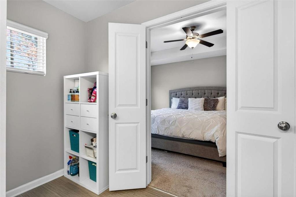 3182 Meadowstone Lane Southwest Atlanta, GA 30331 - Photo 20 of 32 a bedroom with bed and a chandelier