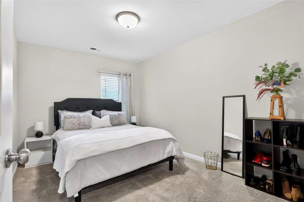 3182 Meadowstone Lane Southwest Atlanta, GA 30331 - Photo 23 of 32 a bedroom with a bed and a window