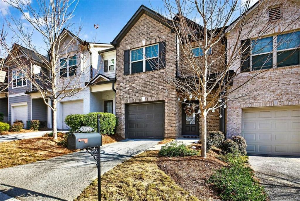3182 Meadowstone Lane Southwest Atlanta, GA 30331 - Photo 4 of 32 a front view of a house with garden and plants