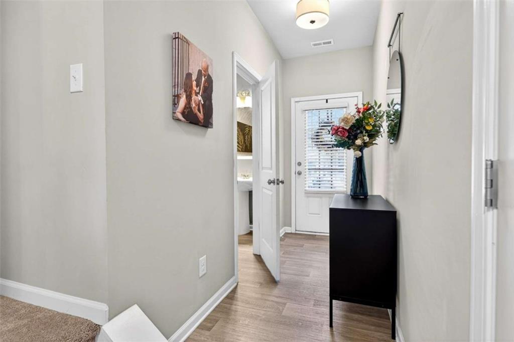 3182 Meadowstone Lane Southwest Atlanta, GA 30331 - Photo 7 of 32 a view of a hallway with wooden floor and a potted plant