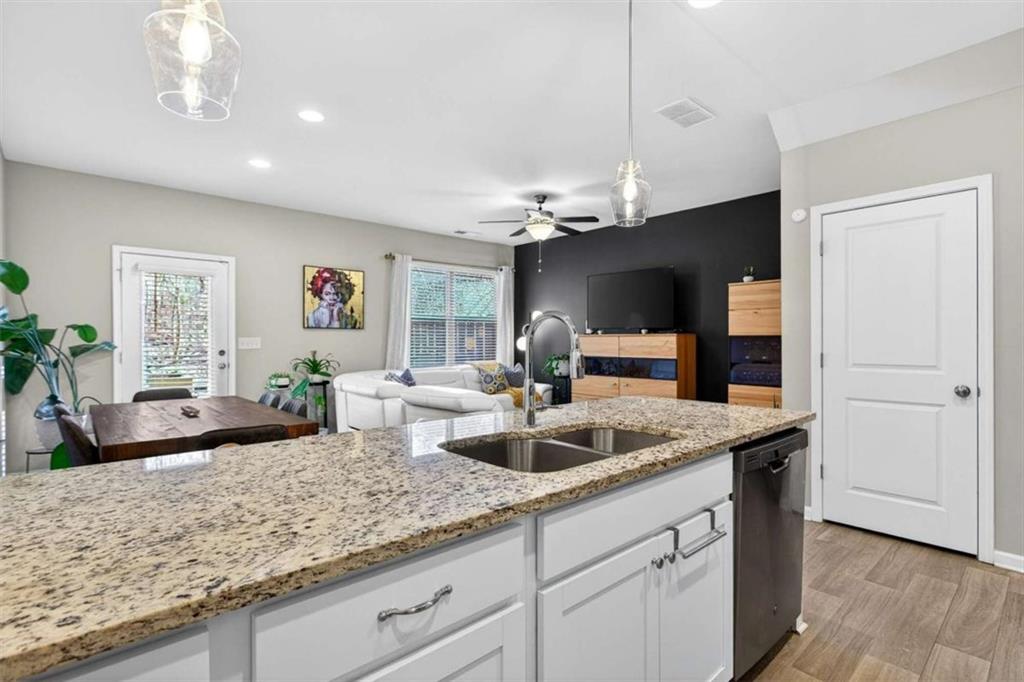 3182 Meadowstone Lane Southwest Atlanta, GA 30331 - Photo 10 of 32 a kitchen with granite countertop a sink and a refrigerator