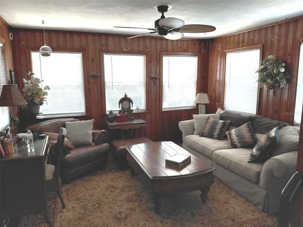 a bedroom with a bed and dresser with mirror