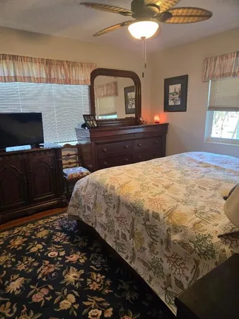 a bedroom with bed and wooden floor