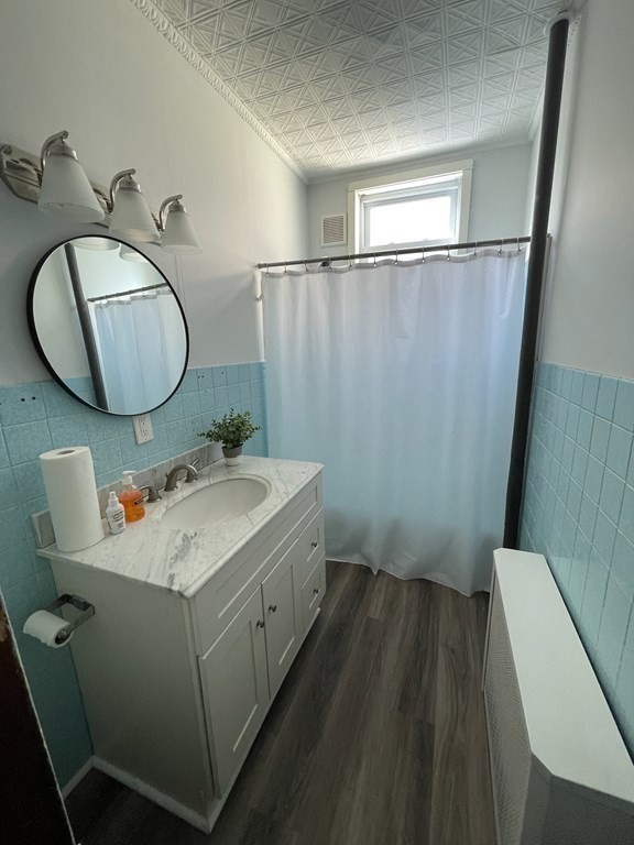 102-104 Allyn Street Holyoke, MA 01040 - Photo 11 of 26 a bathroom with a sink mirror vanity and toilet
