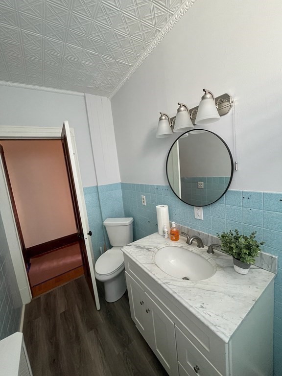 102-104 Allyn Street Holyoke, MA 01040 - Photo 12 of 26 a bathroom with a granite countertop sink toilet and a mirror