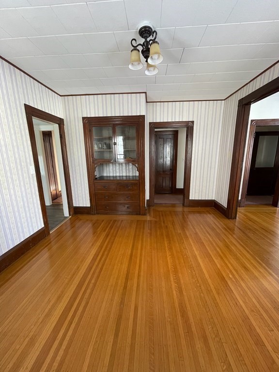 102-104 Allyn Street Holyoke, MA 01040 - Photo 15 of 26 an empty room with wooden floor and windows