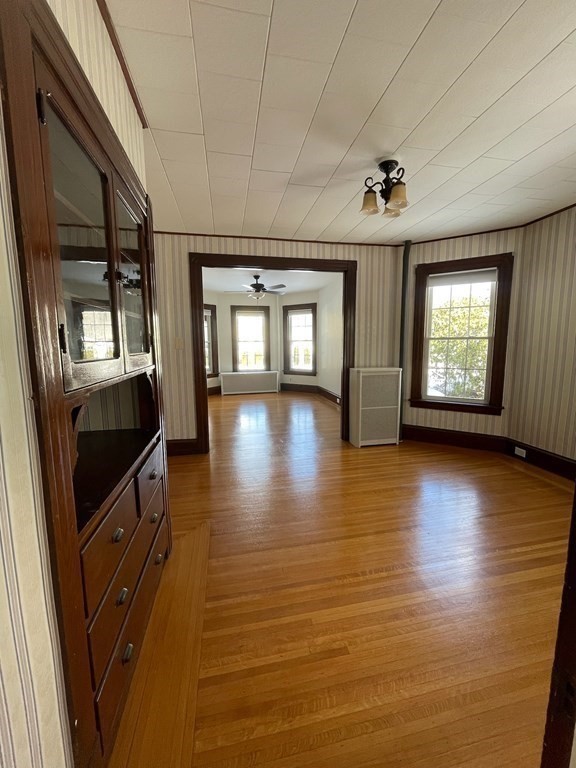 102-104 Allyn Street Holyoke, MA 01040 - Photo 17 of 26 an empty room with wooden floor and windows