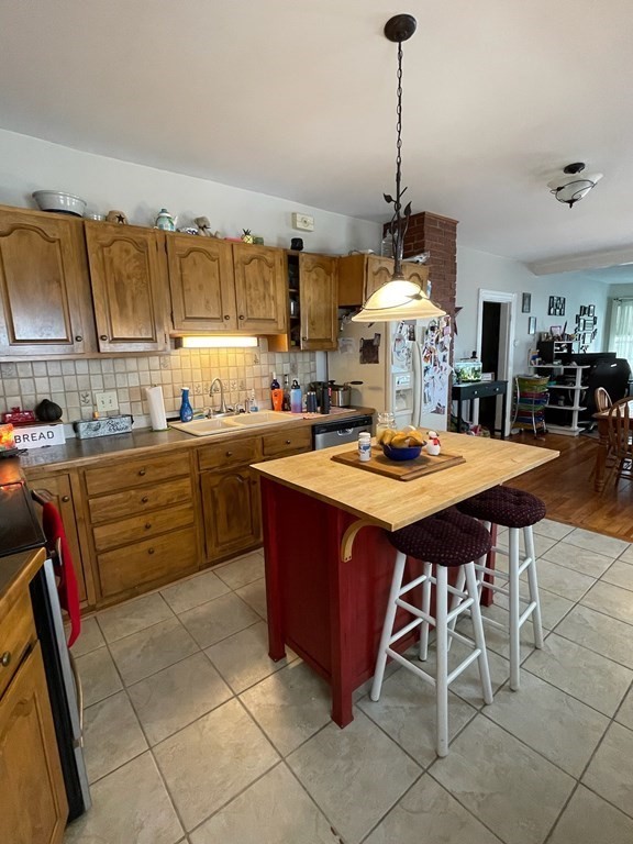 102-104 Allyn Street Holyoke, MA 01040 - Photo 2 of 26 a kitchen with a sink a stove and chairs