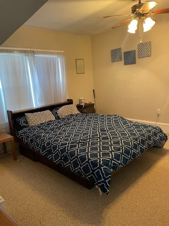 102-104 Allyn Street Holyoke, MA 01040 - Photo 22 of 26 a bed sitting in a bedroom next to a window