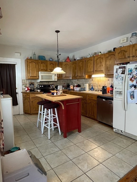 102-104 Allyn Street Holyoke, MA 01040 - Photo 4 of 26 a kitchen with stainless steel appliances granite countertop a stove a sink dishwasher and a refrigerator