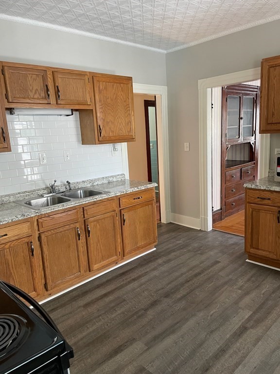102-104 Allyn Street Holyoke, MA 01040 - Photo 7 of 26 a kitchen with wooden cabinets and a sink