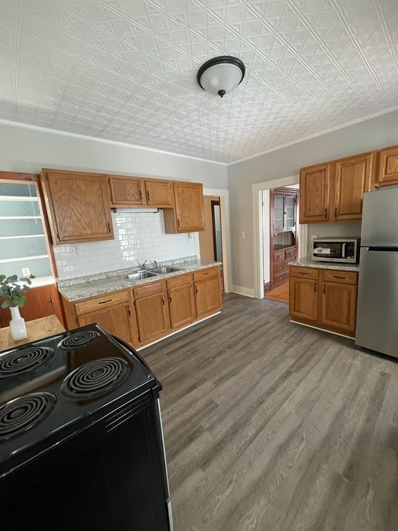 102-104 Allyn Street Holyoke, MA 01040 - Photo 9 of 26 a kitchen with granite countertop a stove and a sink