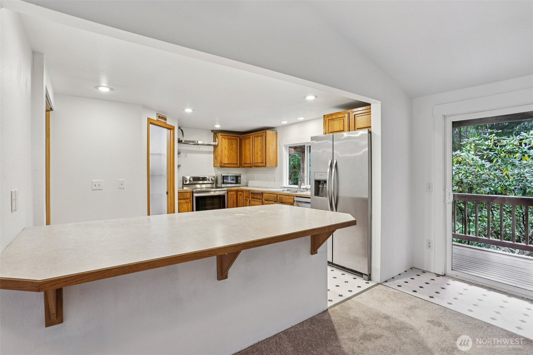 34408 Northeast 111th Street Carnation, WA 98014 - Photo 11 of 34 a kitchen with stainless steel appliances a refrigerator and a stove top oven