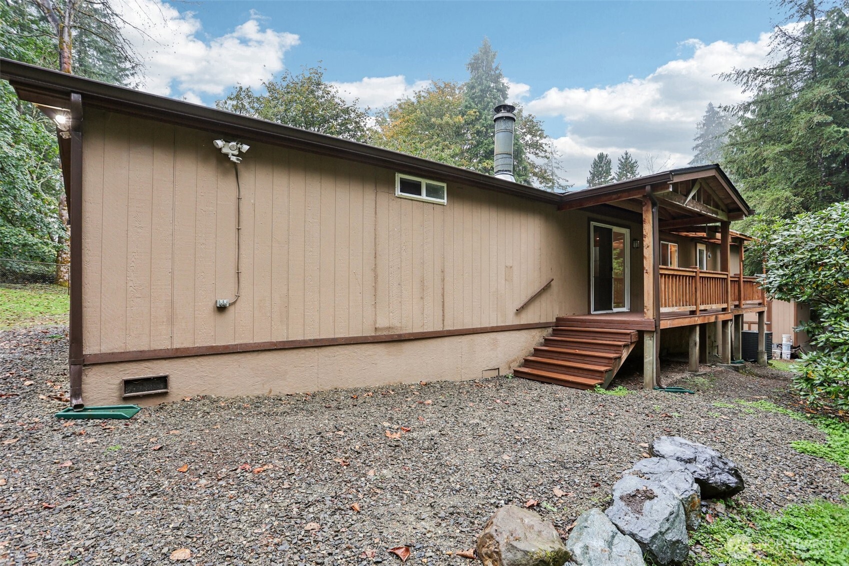 34408 Northeast 111th Street Carnation, WA 98014 - Photo 22 of 34 a backyard of a house with wooden fence and trees