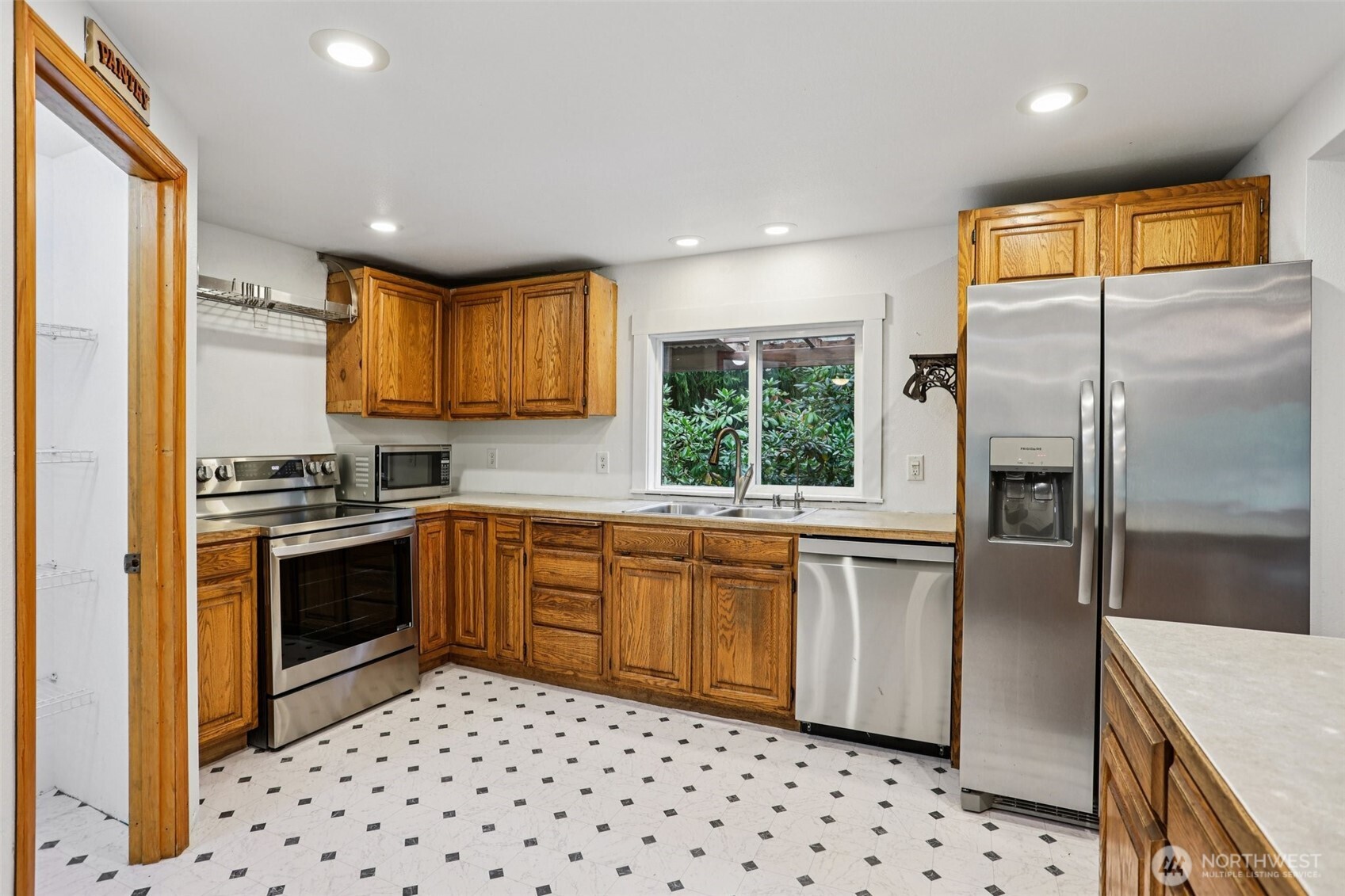 34408 Northeast 111th Street Carnation, WA 98014 - Photo 6 of 34 a kitchen with stainless steel appliances a refrigerator sink and microwave