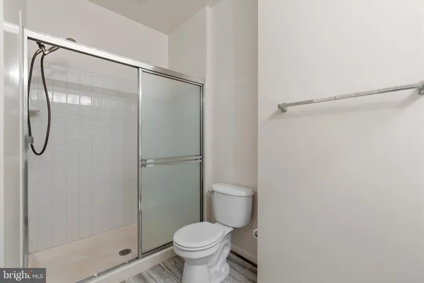 a bathroom with a glass shower door