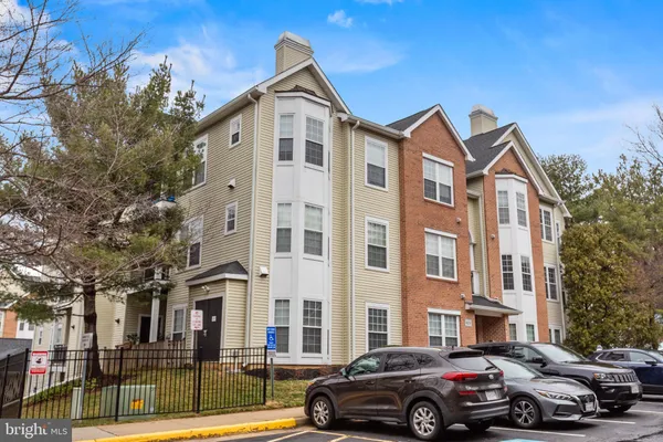 a front view of a residential apartment building with a yard