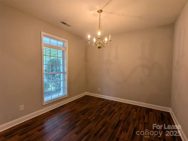 a view of a room with wooden floor and window