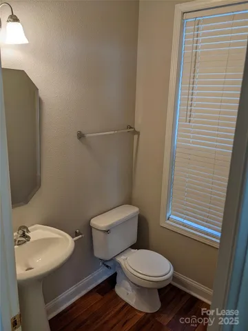 a white toilet sitting next to a bathroom sink