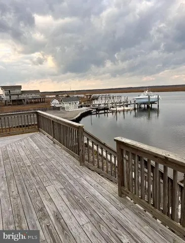 a view of roof deck with two chairs and wooden floor