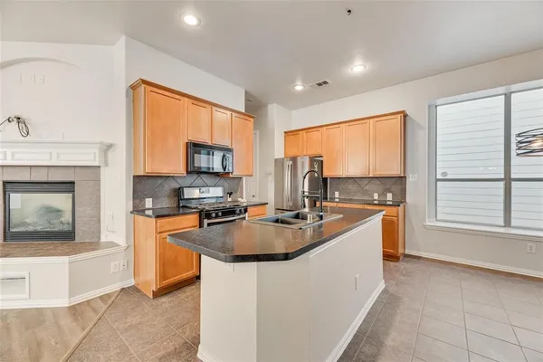 a kitchen with sink refrigerator and microwave