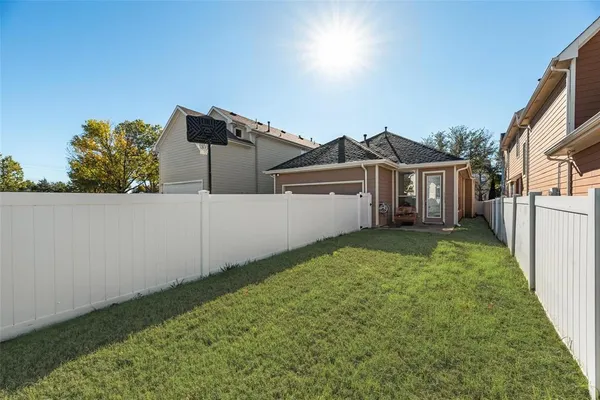 a view of a house with a backyard
