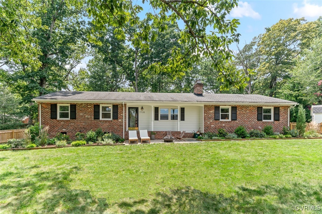 7735 Cherokee Road Richmond, VA 23225 - Photo 2 of 33 a front view of a house with a garden