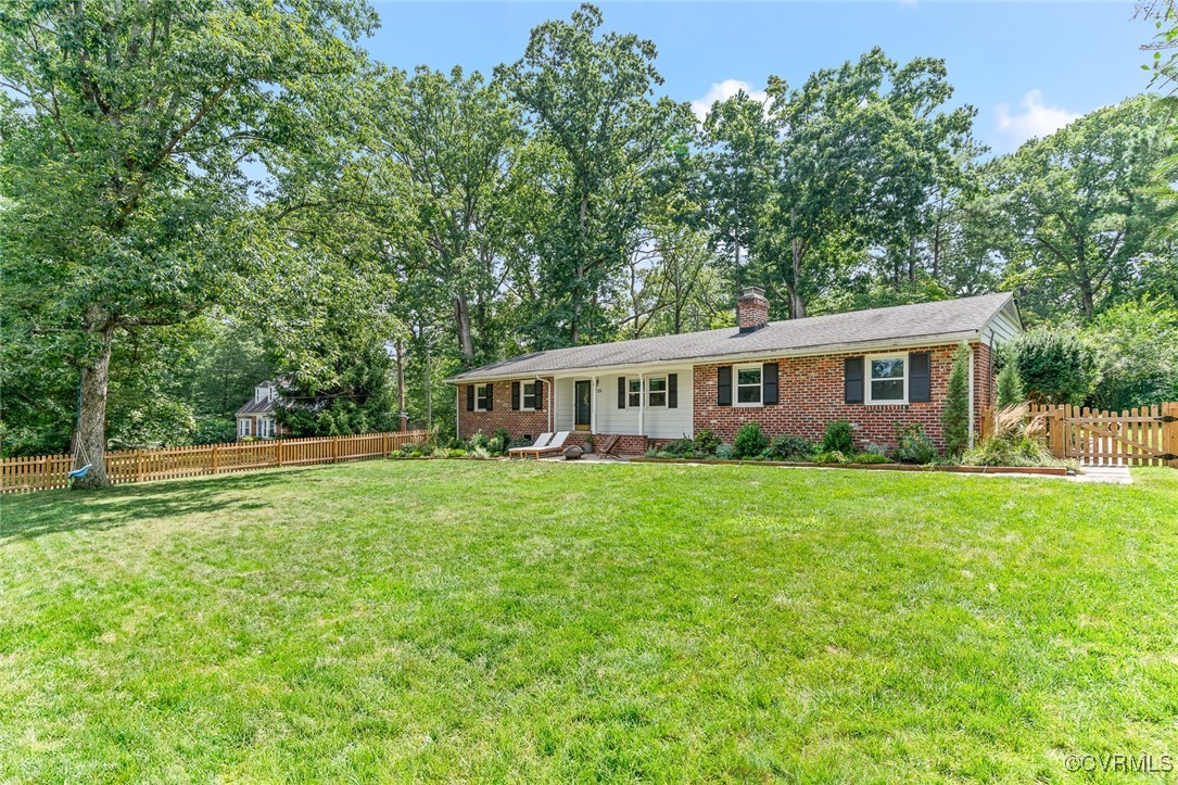 7735 Cherokee Road Richmond, VA 23225 - Photo 5 of 33 a view of a house and a yard with large trees