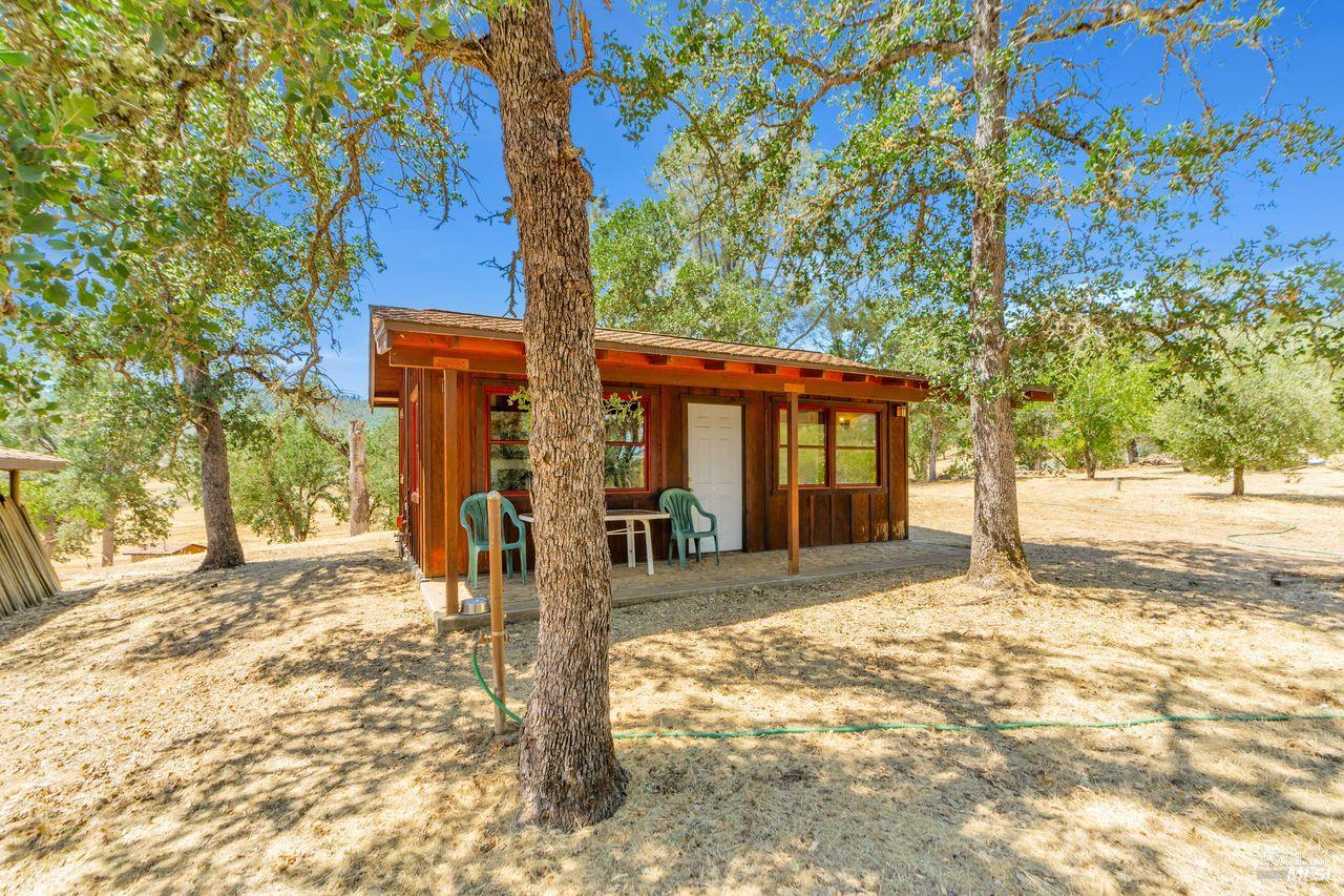 17277 Butts Canyon Road Middletown, CA 95461 - Photo 20 of 41 a front view of a house with a tree in the yard