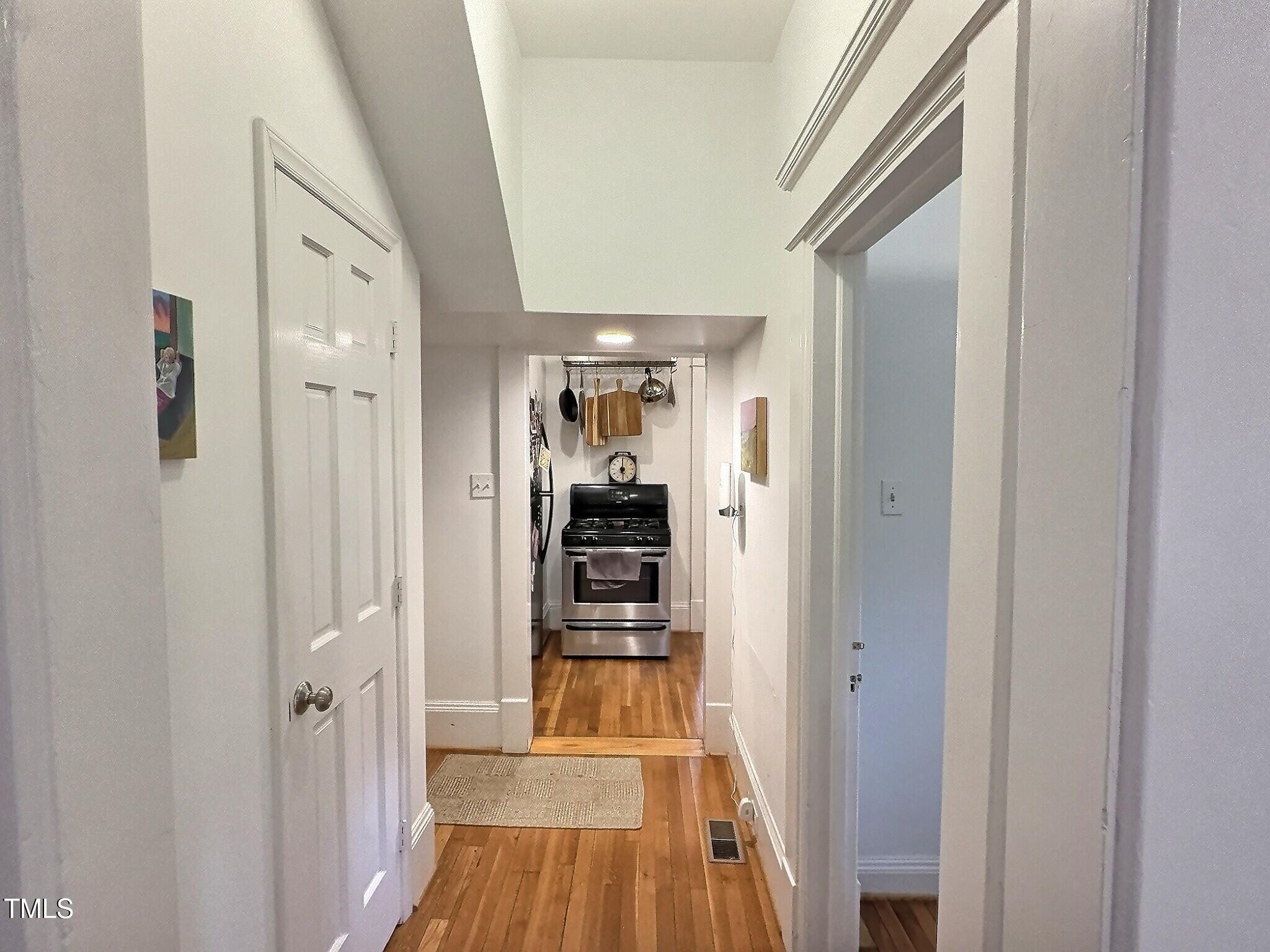 901 West Markham Avenue Durham, NC 27701 - Photo 14 of 38 a view of a hallway with wooden floor and dining room
