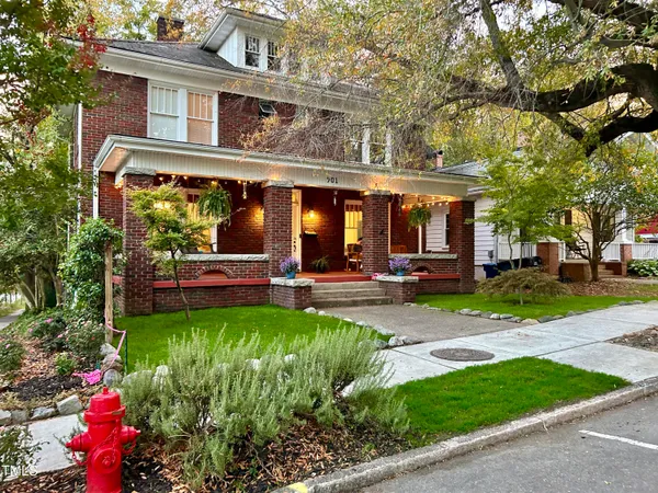 a kitchen with stainless steel appliances granite countertop a refrigerator a sink dishwasher and a stove with wooden floor