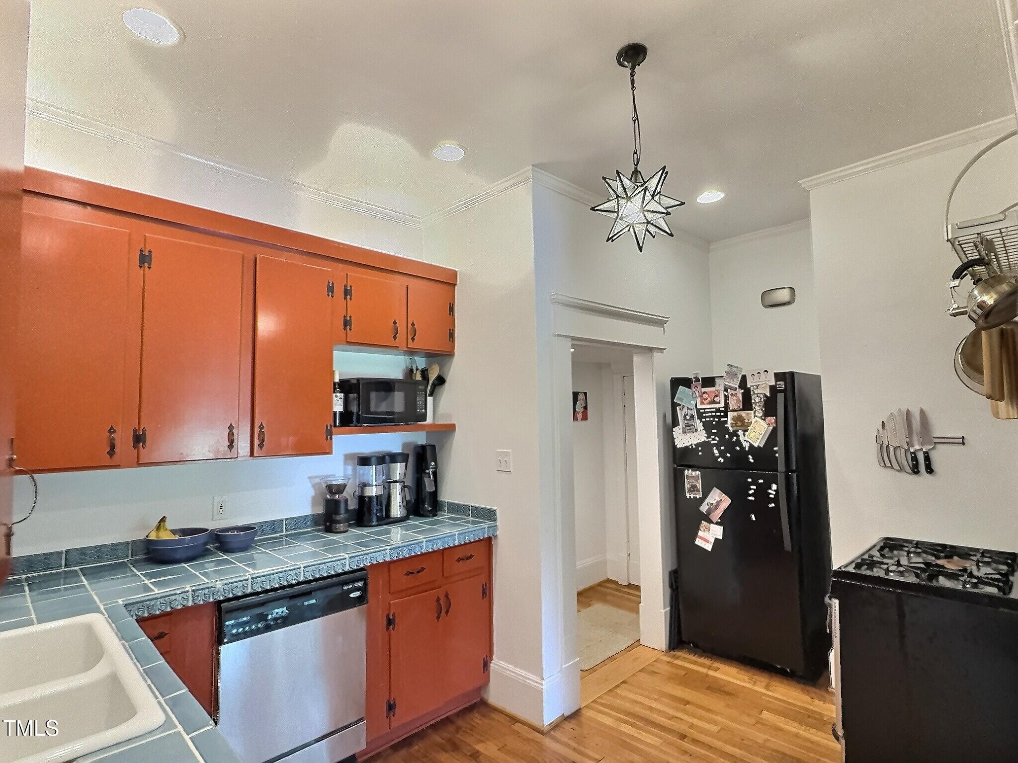 901 West Markham Avenue Durham, NC 27701 - Photo 20 of 38 a kitchen with stainless steel appliances granite countertop a refrigerator a sink dishwasher and a stove with wooden floor