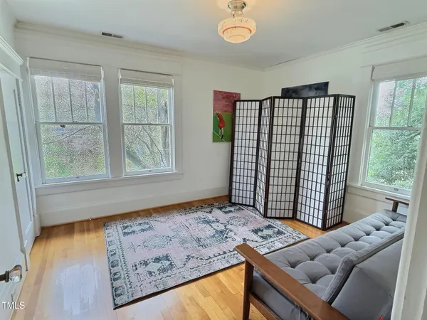 a living room with hard wood floors and a window
