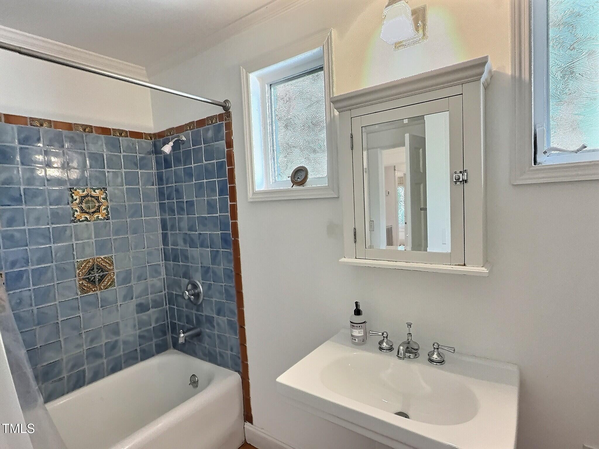 901 West Markham Avenue Durham, NC 27701 - Photo 24 of 38 a bathroom with a shower a sink and a bathtub