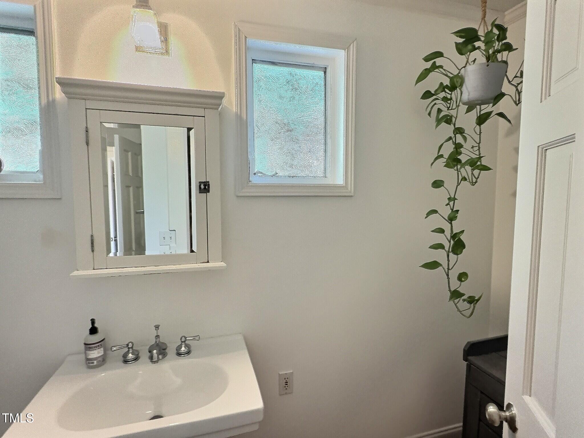 901 West Markham Avenue Durham, NC 27701 - Photo 25 of 38 a bathroom with a sink a mirror and a toilet