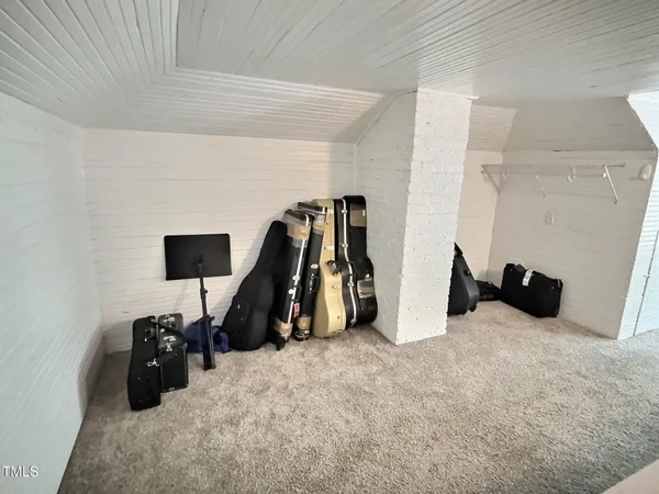 a front view of a house with a tree