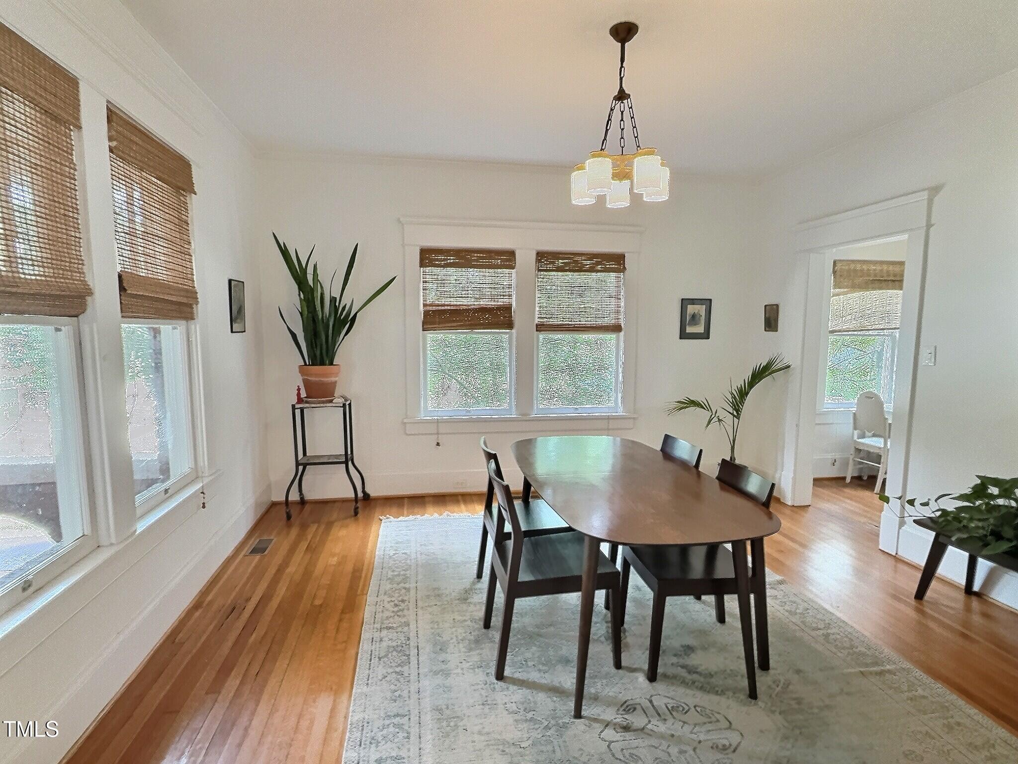 901 West Markham Avenue Durham, NC 27701 - Photo 8 of 38 a view of a dining room with furniture window and wooden floor