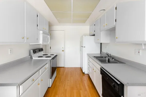 a kitchen with stainless steel appliances a sink a stove and a refrigerator