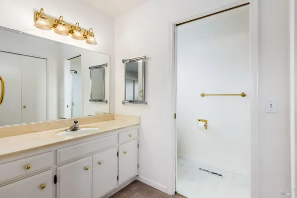 a bathroom with a shower sink and mirror