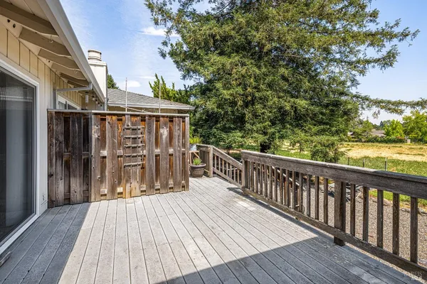a balcony with wooden floor and fence