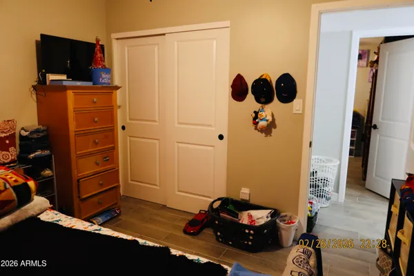 a bedroom with a bed and a flat tv screen