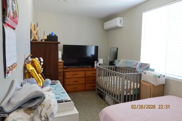 a bedroom with furniture and a flat screen tv