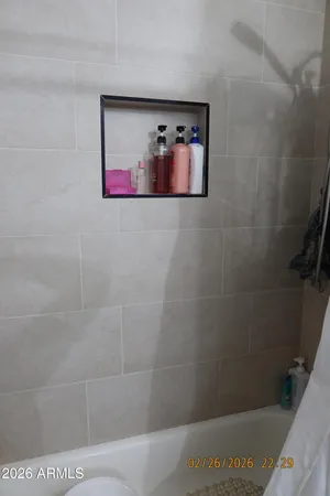 a bathroom with a bathtub and shower