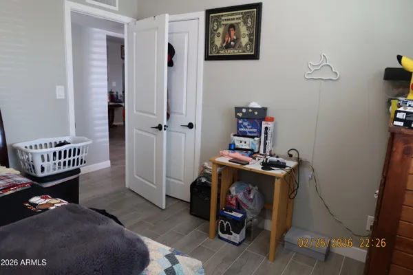 a bedroom with a bed and wooden floor