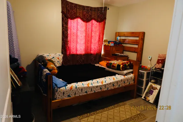 a bed sitting in a bedroom next to a window