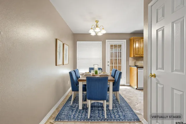 a view of a dining room with furniture and chandelier
