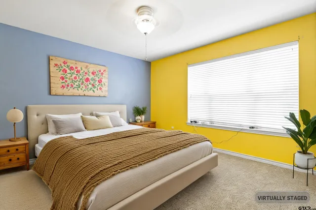 a spacious bedroom with a bed and a window